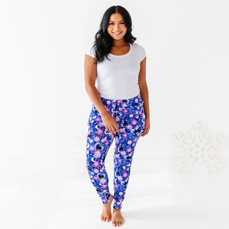 Woman wearing a white t-shirt and blue floral leggings on a white background