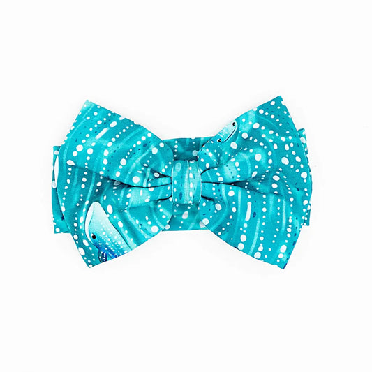 A bow headband with a pattern inspired by a whale shark in teal color.