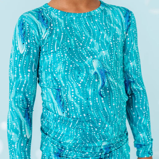 Teal patterned outfit on a light blue background
