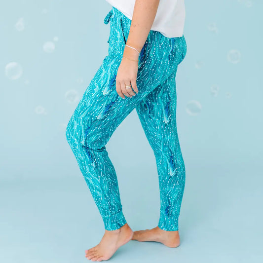 Person wearing blue glittery pants against a blue background