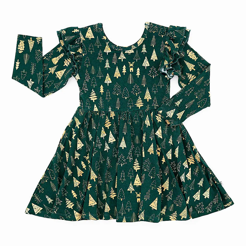 Flat lay of a long sleeve twirl dress with flutter ruffles at the shoulders in a dark green print of gold Christmas trees on a white background.