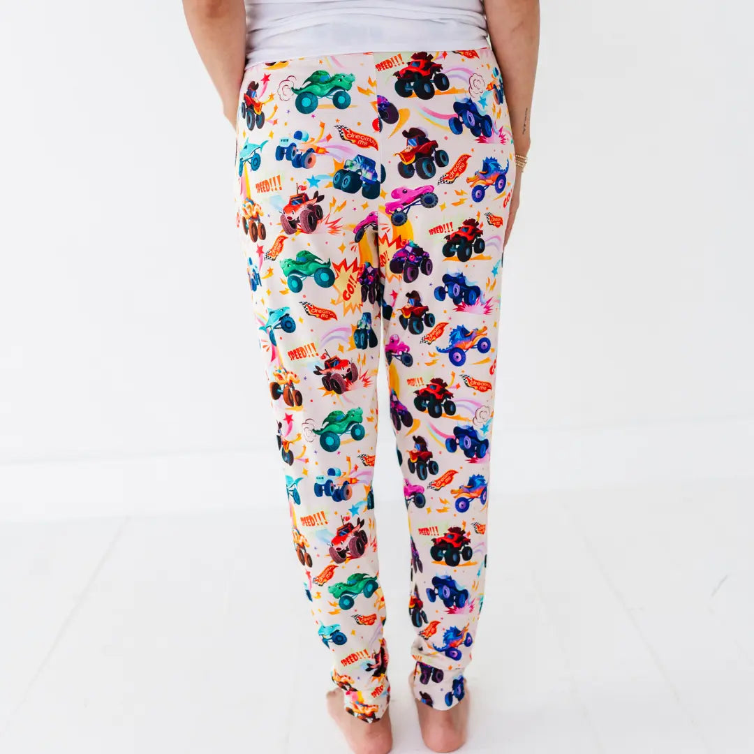 Back view of women's jogger-style pajama pants with a colorful monster truck print.